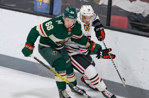 TRAVERSE CITY, MI – SEPTEMBER 10: Will Bitten #86 of the Minnesota Wild battles for the puck with Jake Ryczek #75 of the Chicago Blackhawks during Day-5 of the NHL Prospects Tournament at Centre Ice Arena on September 10, 2019, in Traverse City, Michigan. (Photo by Dave Reginek/NHLI via Getty Images)