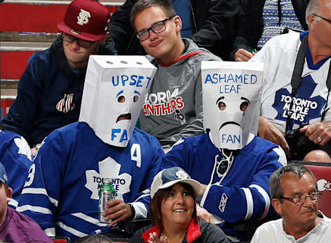 Two Toronto Maple Leafs fans wearing paper bags over their heads watch third period action against the Florida Panthers April 10, 2014 in Sunrise, Florida. (Photo by Joel Auerbach/Getty Images)