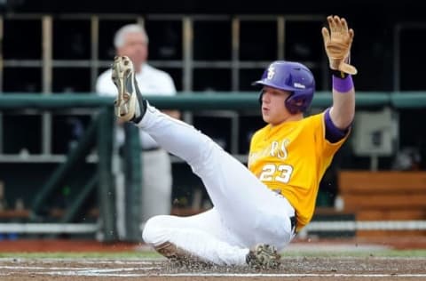 Jun 18, 2015; Omaha, NE, USA; LSU Tigers outfielder Jake Fraley (23) slides in with the first run of the game in the first inning against the TCU Horned Frogs in the 2015 College World Series at TD Ameritrade Park. Mandatory Credit: Steven Branscombe-USA TODAY Sports