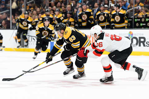 BOSTON, MA – OCTOBER 12: Karson Kuhlman #83 of the Boston Bruins skates past Jack Hughes #86 of the New Jersey Devils in the first period at TD Garden on October 12, 2019 in Boston, Massachusetts. (Photo by Kathryn Riley/Getty Images)