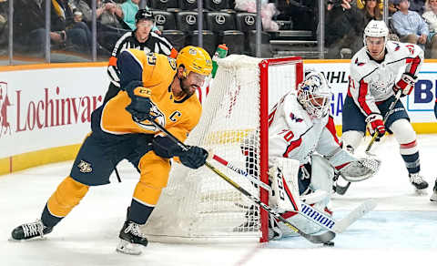 NASHVILLE, TN – OCTOBER 10: Roman Josi #59 of the Nashville Predators brings the puck around the net against Braden Holtby #70 of the Washington Capitals at Bridgestone Arena on October 10, 2019 in Nashville, Tennessee. (Photo by John Russell/NHLI via Getty Images)