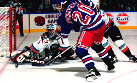 2000 Season: Islander goalie Eric Fichaud sticks asided scoring attempt by Luc Robitaille of the New York Rangers. (Photo by John Giamundo/Getty Images)