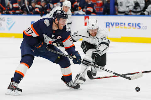 Nov. 16, 2022; Edmonton, Alberta, CAN; Los Angeles Kings forward Viktor Arvidsson (33) tries to knock the puck away from Edmonton Oilers forward Connor McDavid (97) during the first period at Rogers Place. Mandatory Credit: Perry Nelson-USA TODAY Sports