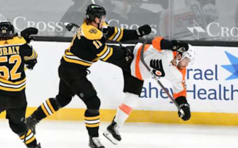 Jan 21, 2021; Boston, Massachusetts, USA; Boston Bruins center Trent Frederic (11) checks Philadelphia Flyers defenseman Mark Friedman (3) during the first period at the TD Garden. Mandatory Credit: Brian Fluharty-USA TODAY Sports