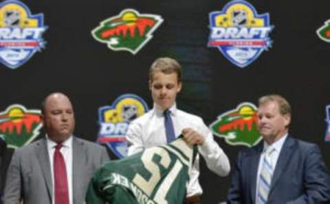 Jun 26, 2015; Sunrise, FL, USA; Joel Eriksson puts on his team jersey after being selected as the number twenty overall pick to the Minnesota Wild in the first round of the 2015 NHL Draft at BB&T Center. Mandatory Credit: Steve Mitchell-USA TODAY Sports