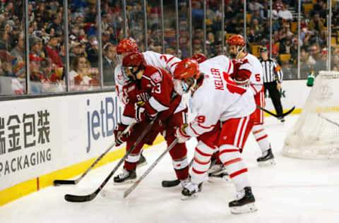 BOSTON, MA – FEBRUARY 13: Harvard University Crimson forward Nathan Krusko (13) fights with Boston University Terriers defenseman Charlie McAvoy (7) and forward Clayton Keller (19) for possession of the puck during the second period of the Beanpot Tournament championship game between the Harvard Crimson and the Boston University Terriers on February 13th, 2017 at TD Garden in Boston, MA. (Photo by John Kavouris/Icon Sportswire via Getty Images)