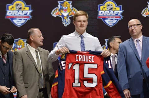 Jun 26, 2015; Sunrise, FL, USA; Lawson Crouse is presented with his team jersey after being selected as the number eleven overall pick to the Florida Panthers in the first round of the 2015 NHL Draft at BB&T Center. Mandatory Credit: Steve Mitchell-USA TODAY Sports