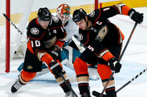 ANAHEIM, CA: Corey Perry #10 and Ryan Getzlaf #15 of the Anaheim Ducks battle for the puck against Aaron Dell #30 of the San Jose Sharks on January 21, 2018. (Photo by Debora Robinson/NHLI via Getty Images)