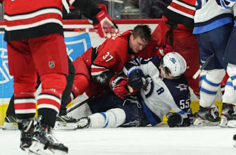 RALEIGH, NC – JANUARY 21: Carolina Hurricanes Left Wing Andrei Svechnikov (37) and Winnipeg Jets Center Mark Scheifele (55) fall to the ice after a fight during a game between the Carolina Hurricanes and the Winnipeg Jets on January 21, 2020 at the PNC Arena in Raleigh, NC. (Photo by Greg Thompson/Icon Sportswire via Getty Images)