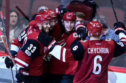 NHL Power Rankings: Arizona Coyotes center Tobias Rieder (8) celebrates with center Alexander Burmistrov (91), defenseman Alex Goligoski (33) ad defenseman Jakob Chychrun (6) after scoring the game winning goal in overtime to beat the Florida Panthers 3-2 at Gila River Arena. Mandatory Credit: Matt Kartozian-USA TODAY Sports