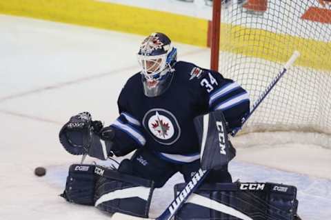 NHL Power Rankings: Winnipeg Jets goalie Michael Hutchinson (34) makes a save prior to the game against Buffalo Sabres at MTS Centre. Mandatory Credit: Bruce Fedyck-USA TODAY Sports