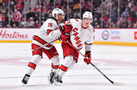 MONTREAL, QC – OCTOBER 21: Ethan Bear #25 of the Carolina Hurricanes and teammate Andrei Svechnikov #37 skate into each other against the Montreal Canadiens during the third period at Centre Bell on October 21, 2021, in Montreal, Canada. The Carolina Hurricanes defeated the Montreal Canadiens 4-1. (Photo by Minas Panagiotakis/Getty Images)