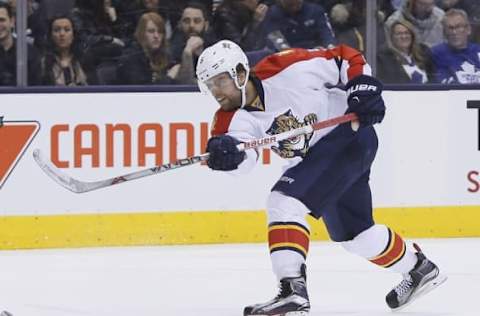 Apr 4, 2016; Toronto, Ontario, CAN; Florida Panthers defenseman Aaron Ekblad (5) shoots the puck against the Toronto Maple Leafs at the Air Canada Centre. Florida defeated Toronto 4-3. Mandatory Credit: John E. Sokolowski-USA TODAY Sports