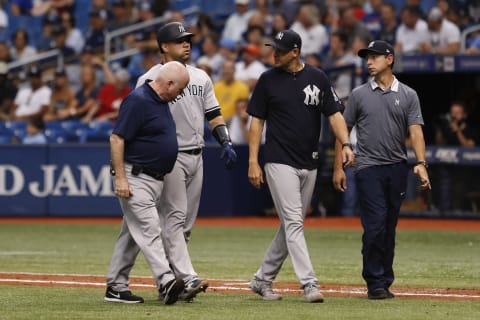 ST. PETERSBURG, FL – JUNE 24: New York Yankees catcher Gary Sanchez (24) walks off the field with New York Yankees manager Aaron Boone (17), Trainer Steve Donohue and Yankees Spanish translator Marlon Abreu after an injury in the 10th inning of the regular season MLB game between the New York Yankees and Tampa Bay Rays on June 24, 2018 at Tropicana Field in St. Petersburg, FL. (Photo by Mark LoMoglio/Icon Sportswire via Getty Images)