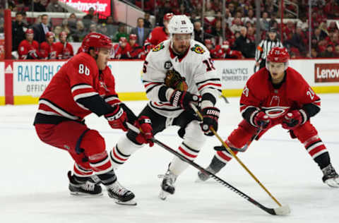 RALEIGH, NC – NOVEMBER 12: Carolina Hurricanes Right Wing Teuvo Teravainen (86) attempts to poke the puck away from Chicago Blackhawks Center Artem Anisimov (15) during a game between the Chicago Blackhawks and the Carolina Hurricanes at the PNC Arena in Raleigh, NC on November 12, 2018. (Photo by Greg Thompson/Icon Sportswire via Getty Images)