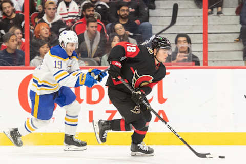 Jan 1, 2023; Ottawa, Ontario, CAN; Ottawa Senators left wing Tim Stutzle (18) skates with the puck in front of Buffalo Sabres center Peyton Krebs (19) in the second period at the Canadian Tire Centre. Mandatory Credit: Marc DesRosiers-USA TODAY Sports