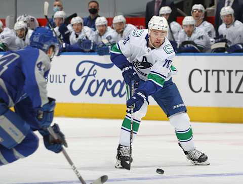 TORONTO, ON – FEBRUARY 6: Tanner Pearson #70 of the Vancouver Canucks looks to grab a puck in front of Morgan Rielly #44 of the Toronto Maple Leafs   (Photo by Claus Andersen/Getty Images)