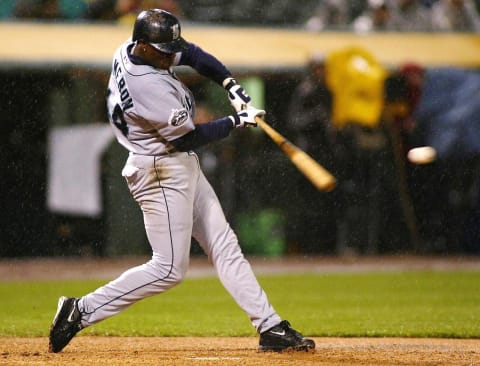 OAKLAND, UNITED STATES: Seattle Mariners’ Mike Cameron hits a two-run RBI double against the Oakland Athletics during the fifth inning before the game was called on a rain delay 16 April 2002 in Oakland, California. AFP PHOTO/John G. MABANGLO (Photo credit should read JOHN G. MABANGLO/AFP/Getty Images)