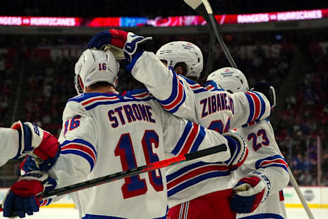 Jan 21, 2022; Raleigh, North Carolina, USA; New York Rangers center Mika Zibanejad (93) celebrates his goal with center Ryan Strome (16) and defenseman Adam Fox (23) against the Carolina Hurricanes during the second period at PNC Arena. Mandatory Credit: James Guillory-USA TODAY Sports