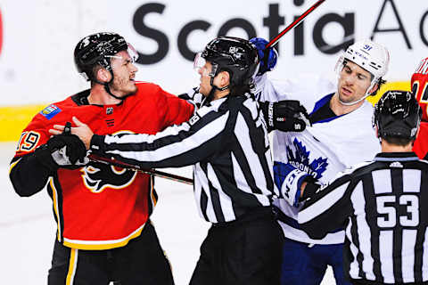 CALGARY, AB – JANUARY 24: Matthew Tkachuk #19 of the Calgary Flames shoves John Tavares #91 of the Toronto Maple Leafs (Photo by Derek Leung/Getty Images)