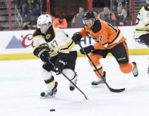 Jan 13, 2016; Philadelphia, PA, USA; Boston Bruins defenseman Torey Krug (47) carries the puck out of the zone past Philadelphia Flyers defenseman Evgeny Medvedev (82) during the second period at Wells Fargo Center. Mandatory Credit: Eric Hartline-USA TODAY Sports