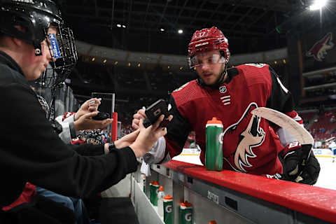 GLENDALE, AZ – FEBRUARY 28: Alex Galchenyuk #17 of the Arizona Coyotes signs a practice puck for a youth hockey player prior to a game against the Vancouver Canucks at Gila River Arena on February 28, 2019 in Glendale, Arizona. (Photo by Norm Hall/NHLI via Getty Images)