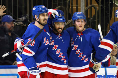 NEW YORK, NEW YORK – DECEMBER 12: Vincent Trocheck #16 of the New York Rangers (C) celebrates his powerplay goal against the New Jersey Devils at 13:58 of the second period and is joined by Chris Kreider #20 (L) and Adam Fox #23 (R) at Madison Square Garden on December 12, 2022, in New York City. (Photo by Bruce Bennett/Getty Images)