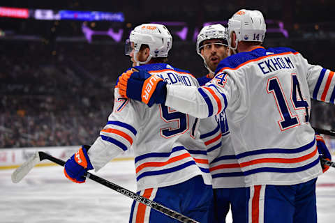 Apr 29, 2023; Los Angeles, California, USA; Edmonton Oilers center Connor McDavid (97) celebrates his goal scored against the Los Angeles Kings with defenseman Mattias Ekholm (14) and defenseman Evan Bouchard (2) during the first period in game six of the first round of the 2023 Stanley Cup Playoffs at Crypto.com Arena. Mandatory Credit: Gary A. Vasquez-USA TODAY Sports