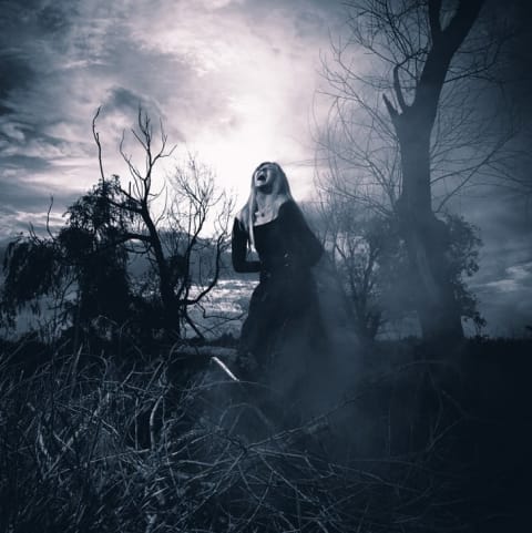 A screaming witchy-looking woman in the fog