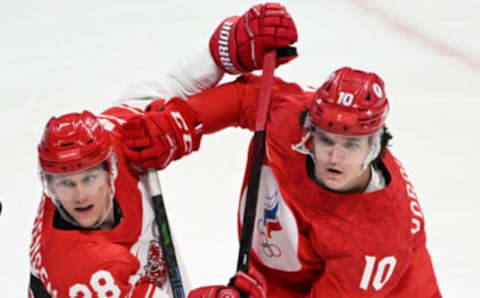 Denmark’s Emil Kristensen and Russian Olympic Committee’s Dmitrii Voronkov vie during the men’s play-off quarterfinal match of the Beijing 2022 Winter Olympic Games ice hockey competition between the Russian Olympic Committee and Denmark, at the Wukesong Sports Centre in Beijing on February 16, 2022. (Photo by Kirill KUDRYAVTSEV / AFP) (Photo by KIRILL KUDRYAVTSEV/AFP via Getty Images)