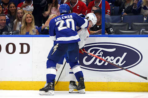 TAMPA, FLORIDA – JUNE 28: Cole Caufield #22 of the Montreal Canadiens is checked into the boards by Blake Coleman #20 of the Tampa Bay Lightning   (Photo by Bruce Bennett/Getty Images)