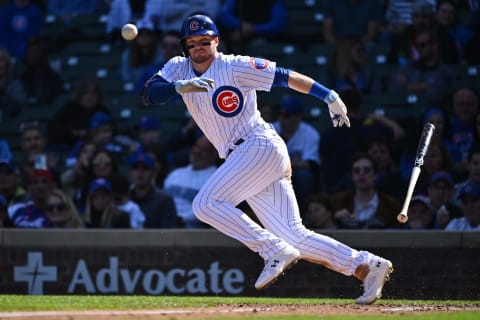 CHICAGO, IL – OCTOBER 2: Ian Happ #8 of the Chicago Cubs lays down a bunt for a single in the second inning against the Cincinnati Reds at Wrigley Field on October 2, 2022 in Chicago, Illinois. (Photo by Jamie Sabau/Getty Images)