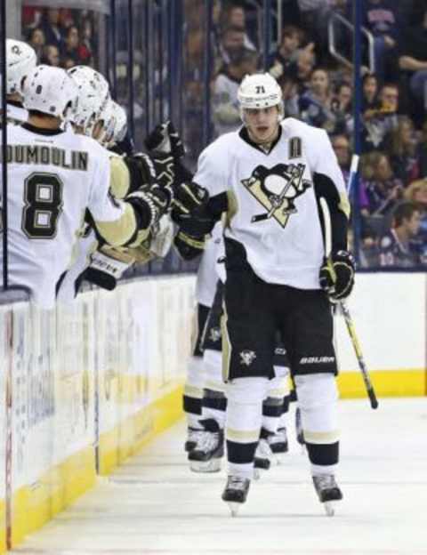 Mar 11, 2016; Columbus, OH, USA; Pittsburgh Penguins center Evgeni Malkin (71) celebrates with teammates on the bench after assisting on a goal from left wing Carl Hagelin (not pictured) in the second period at Nationwide Arena. The Penguins won 3-2. Mandatory Credit: Aaron Doster-USA TODAY Sports