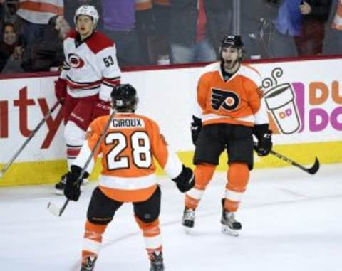 Dec 15, 2015; Philadelphia, PA, USA; Philadelphia Flyers defenseman Shayne Gostisbehere (53) celebrates scoring the game winning goal with center Claude Giroux (28) against the Carolina Hurricanes during overtime at Wells Fargo Center. The Flyers defeated the Hurricanes, 4-3 in overtime. Mandatory Credit: Eric Hartline-USA TODAY Sports