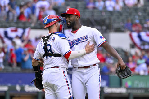 Apr 1, 2023; Arlington, Texas, USA; Texas Rangers relief pitcher Taylor Hearn (52) and catcher Mitch Garver (18) celebrate the victory over the Philadelphia Phillies at Globe Life Field. Mandatory Credit: Jerome Miron-USA TODAY Sports