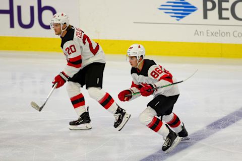 Blake Coleman #20 and Jack Hughes #86 of the New Jersey Devils (Photo by Mitchell Leff/Getty Images)