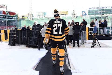 Jan 1, 2023; Boston, MA, USA; Boston Bruins defenseman Hampus Lindholm (27) walks to the ice during a practice day before the 2023 Winter Classic ice hockey game at Fenway Park. Mandatory Credit: Bob DeChiara-USA TODAY Sports