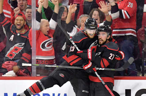 RALEIGH, NORTH CAROLINA – MAY 01: Justin Faulk #27 celebrates with Warren Foegele #13 of the Carolina Hurricanes after scoring against the New York Islanders during the second period of Game Three of the Eastern Conference Second Round during the 2019 NHL Stanley Cup Playoffs at PNC Arena on May 01, 2019 in Raleigh, North Carolina. (Photo by Grant Halverson/Getty Images)