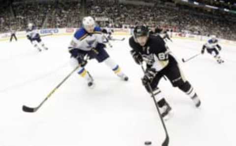 Nov 25, 2015; Pittsburgh, PA, USA; Pittsburgh Penguins center Sidney Crosby (87) moves the puck against pressure from St. Louis Blues defenseman Colton Parayko (55) during the second period at the CONSOL Energy Center. Mandatory Credit: Charles LeClaire-USA TODAY Sports