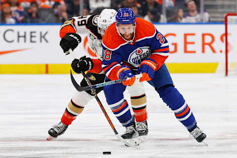 Nov 26, 2023; Edmonton, Alberta, CAN; Edmonton Oilers forward Connor Brown (28) and Anaheim Ducks forward Max Jones (49) chase a loose puck during the third period at Rogers Place. Mandatory Credit: Perry Nelson-USA TODAY Sports