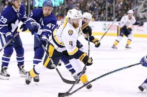 NHL Trade Rumors: Nashville Predators defenseman Ryan Ellis (4) shoots the puck as Toronto Maple Leafs center Leo Komarov (47) backchecks at Air Canada Centre. Mandatory Credit: Tom Szczerbowski-USA TODAY Sports