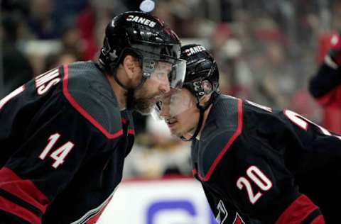 RALEIGH, NC – MAY 14: Justin Williams #13 of the Carolina Hurricanes and teammate Sebastian Aho #20 converse in Game Three of the Eastern Conference Third Round against the Boston Bruins during the 2019 NHL Stanley Cup Playoffs on May 14, 2019 at PNC Arena in Raleigh, North Carolina. (Photo by Gregg Forwerck/NHLI via Getty Images)