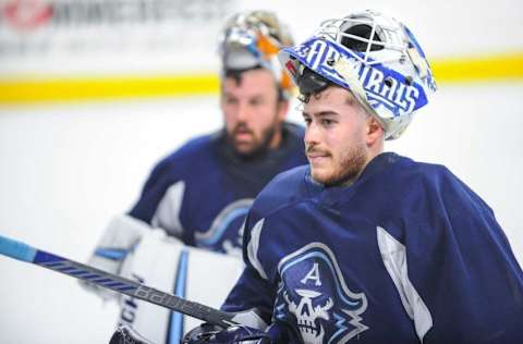 Goaltenders Yaroslav Askarov, foreground, and Troy Grosenick listen to instructions during a break in Milwaukee Admirals practice Friday, October 13, 2023, at the UW-Milwaukee Panther Arena in Milwaukee, Wisconsin.