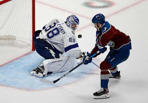 Jun 15, 2022; Denver, Colorado, USA; Tampa Bay Lightning goaltender Andrei Vasilevskiy (88) pokes the puck away from Colorado Avalanche left wing J.T. Compher (37) during the second period of game one of the 2022 Stanley Cup Final at Ball Arena. Lightning. Mandatory Credit: Isaiah J. Downing-USA TODAY Sports