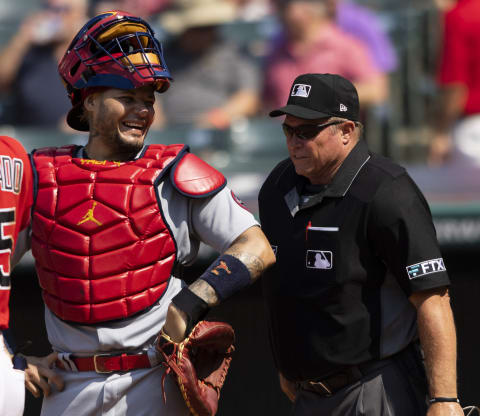 Jul 28, 2021; Cleveland, Ohio, USA; St. Louis Cardinals catcher Yadier Molina (4) laughs with home plate umpire Marvin Hudson during the eighth inning at Progressive Field. Mandatory Credit: Scott Galvin-USA TODAY Sports