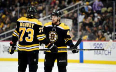 PITTSBURGH, PENNSYLVANIA – APRIL 21: Charlie McAvoy #73 and Matt Grzelcyk #48 of the Boston Bruins talk during a game between the Pittsburgh Penguins and Boston Bruins at PPG PAINTS Arena on April 21, 2022 in Pittsburgh, Pennsylvania. (Photo by Emilee Chinn/Getty Images)