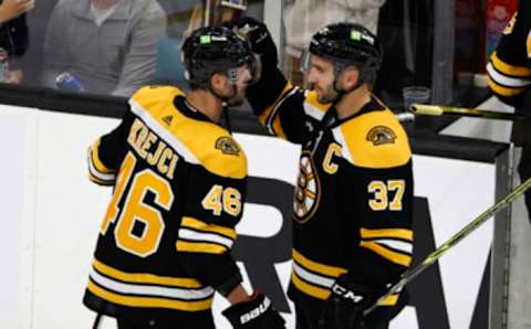 Oct 25, 2022; Boston, Massachusetts, USA; Boston Bruins center Patrice Bergeron (37) congratulates center David Krejci (46) after their 3-1 win over the Dallas Stars at TD Garden. Mandatory Credit: Winslow Townson-USA TODAY Sports