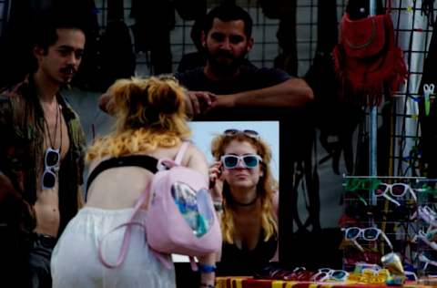 June 8 2017; Manchester, TN, USA; Kate Condiff, of Nashville, tries on a pair of sunglasses in the campgrounds at Bonnaroo Music and Arts Festival. Mandatory Credit: Calvin Mattheis/Knoxville News Sentinel via USA TODAY NETWORK