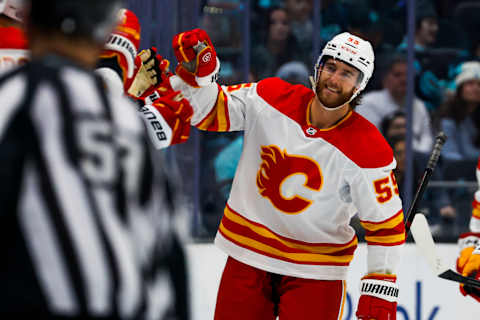 Nov 4, 2023; Seattle, Washington, USA; Calgary Flames defenseman Noah Hanifin (55) celebrates after scoring a goal against the Seattle Kraken during the second period at Climate Pledge Arena. Mandatory Credit: Joe Nicholson-USA TODAY Sports