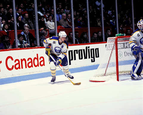 MONTREAL, CANADA- 1990: Dale Hawerchuk #10 of the Buffalo Sabres skates with the puck against the Montreal Canadiens in 1990 at the Montreal Forum in Montreal, Quebec, Canada. (Photo by Denis Brodeur/NHLI via Getty Images)